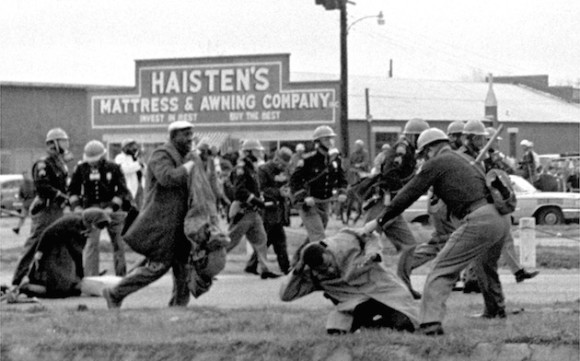 FILE - In this March 7, 1965 file photo, state troopers use clubs against participants of a civil rights voting march in Selma, Ala. At foreground right, John Lewis, chairman of the Student Nonviolent Coordinating Committee, is beaten by a state trooper. The day, which became known as "Bloody Sunday," is widely credited for galvanizing the nation's leaders and ultimately yielded passage of the Voting Rights Act of 1965. (AP Photo/File)