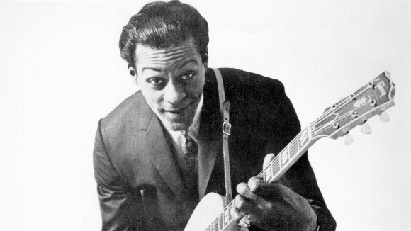 Chuck Berry in 1958, posingÂ with his Gibson hollow-body electricÂ